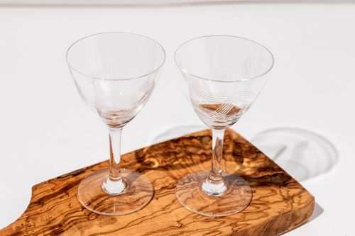 Free Two crystal glasses on a wooden board with bright natural lighting, perfect for elegant settings. Stock Photo