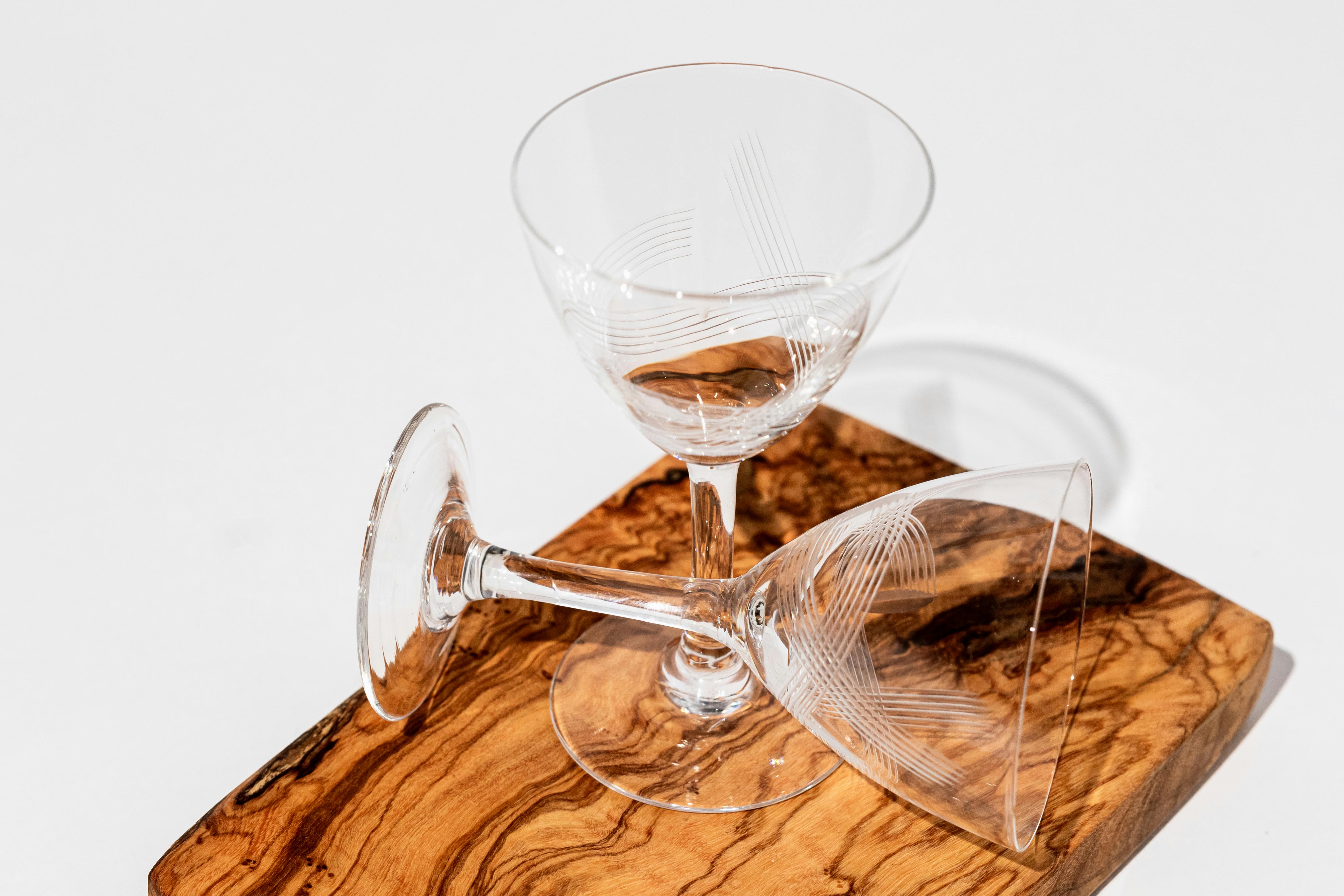 thin tall beverage glasses on a wooden cutboard