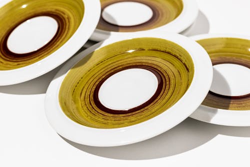 Small white plates with green brown combination of details
