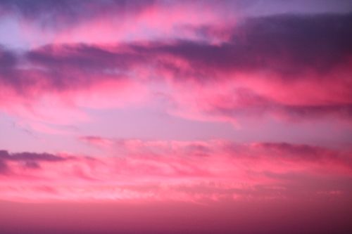 Free A mesmerizing blend of pink and purple clouds at sunset, showcasing nature's beauty. Stock Photo