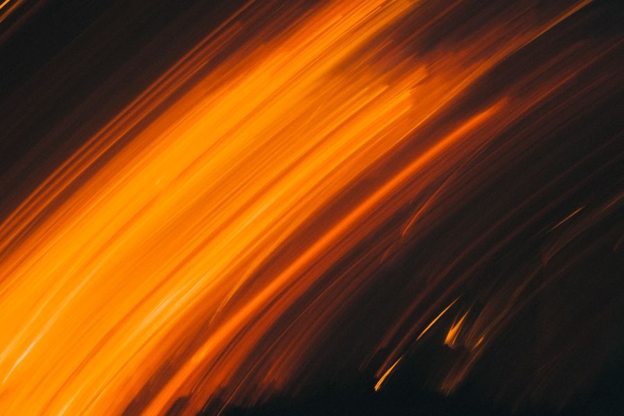 Warm abstract light streaks — photo by Luis Quintero on Pexels