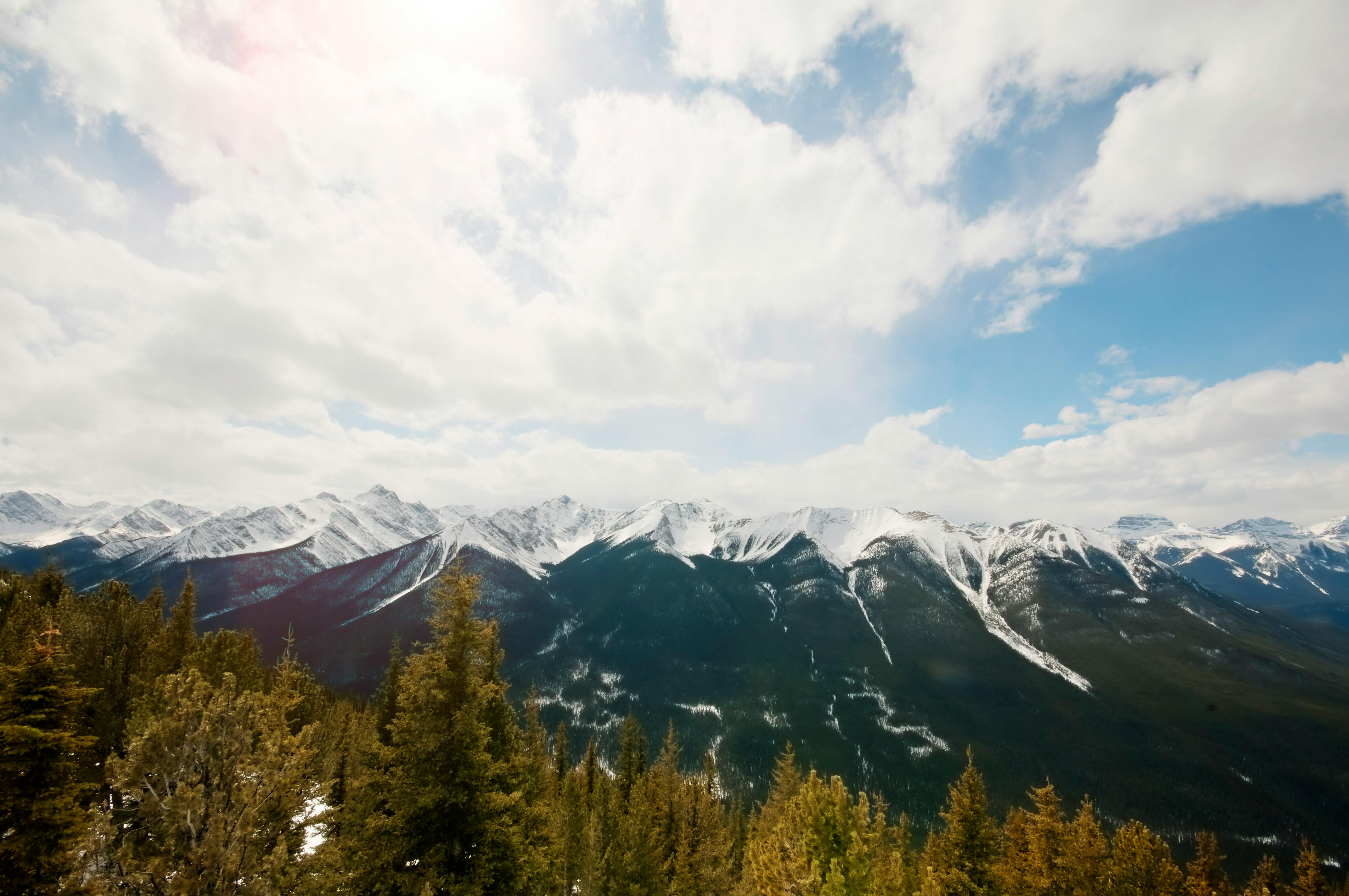 在明亮的蓝天下，落基山脉白雪皑皑，景色壮丽