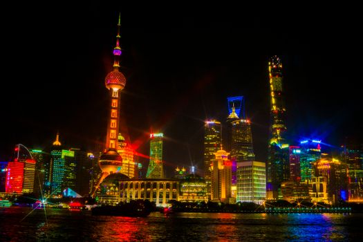 Stunning illuminated skyline of Shanghai featuring the Oriental Pearl Tower at night.