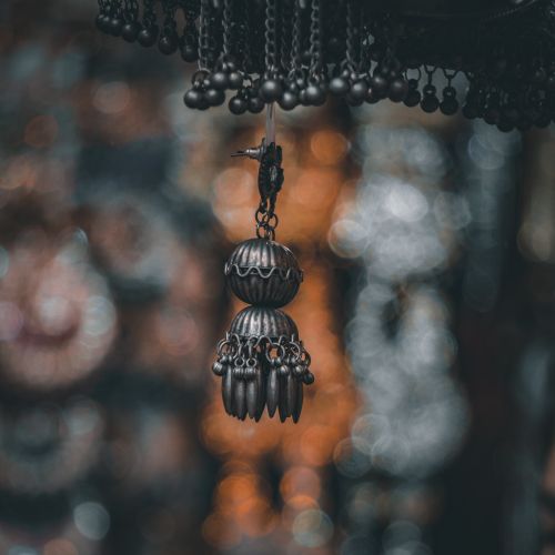 Free A close-up of a decorative black metal hanging ornament with a beautiful bokeh background. Stock Photo
