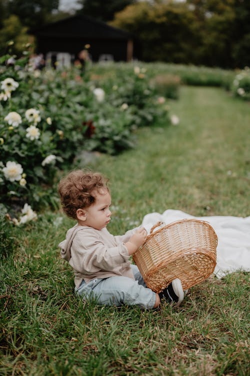 Baby with Basket on Grass