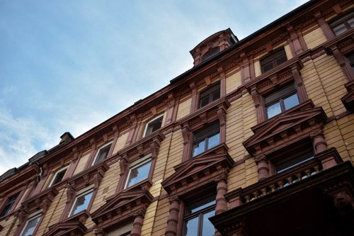 Free Low angle view of a neoclassical residential building facade against a clear sky. Stock Photo