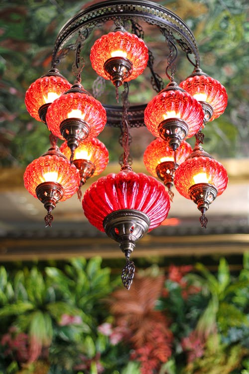 Photo of a Red Glass Chandelier Hanging from a Green Ceiling