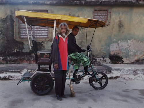 Men with a Rickshaw in Front of a Weathered Building