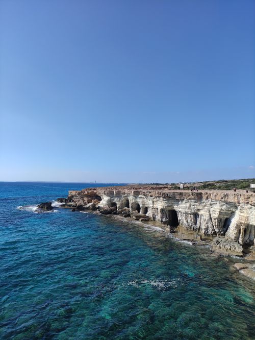 Free Explore the stunning coastal cliffs and azure waters of Cyprus with this breathtaking aerial view. Stock Photo