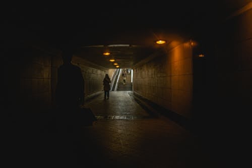 People Walking in Tunnel