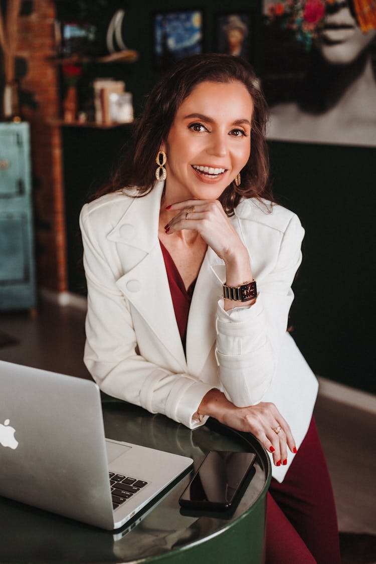 Elegant Woman In White Jacket Sitting At Desk