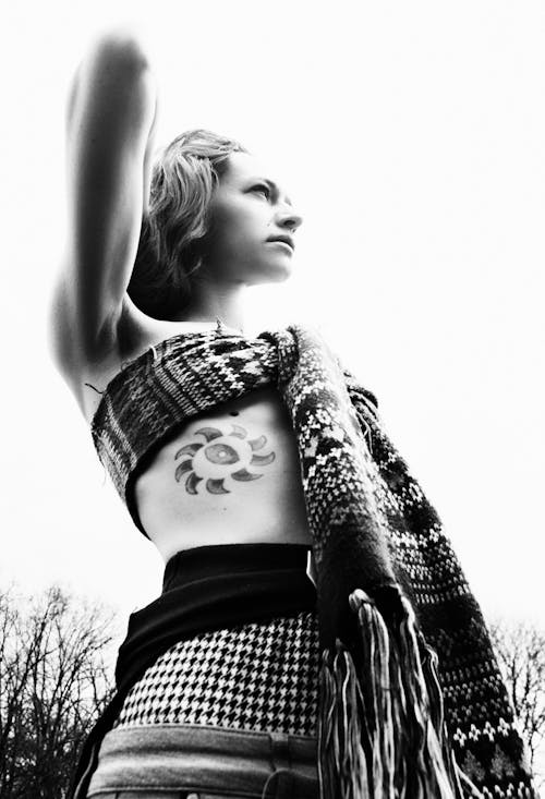 Low Angle Shot of a Woman with a Tattoo Wearing a Scarf on Her Chest