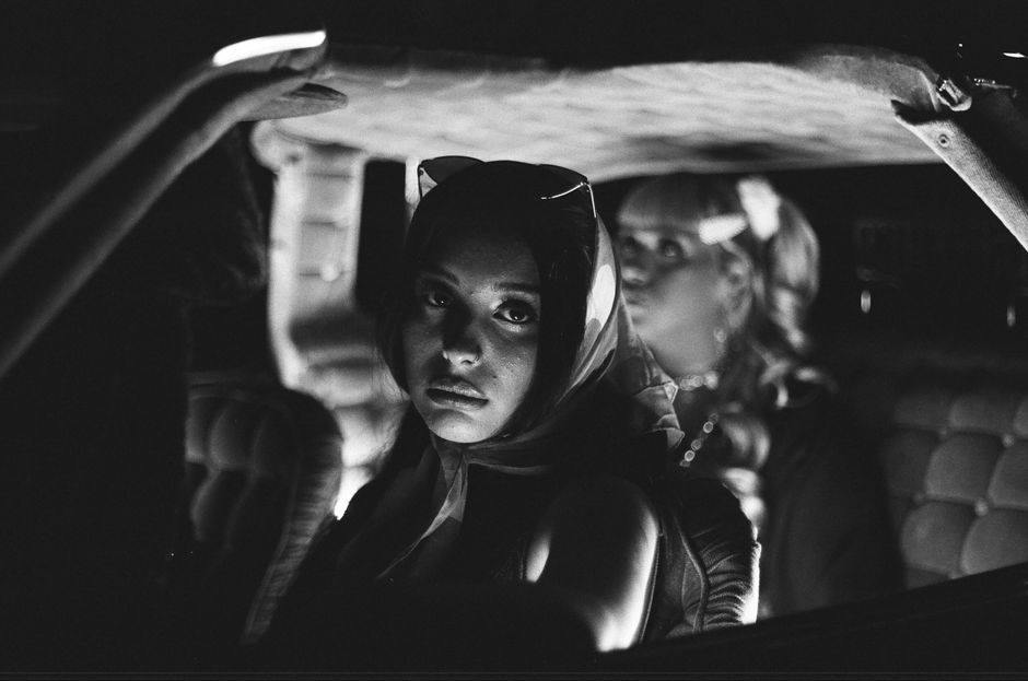 Vintage-style black and white portrait shot inside a car in Los Angeles.