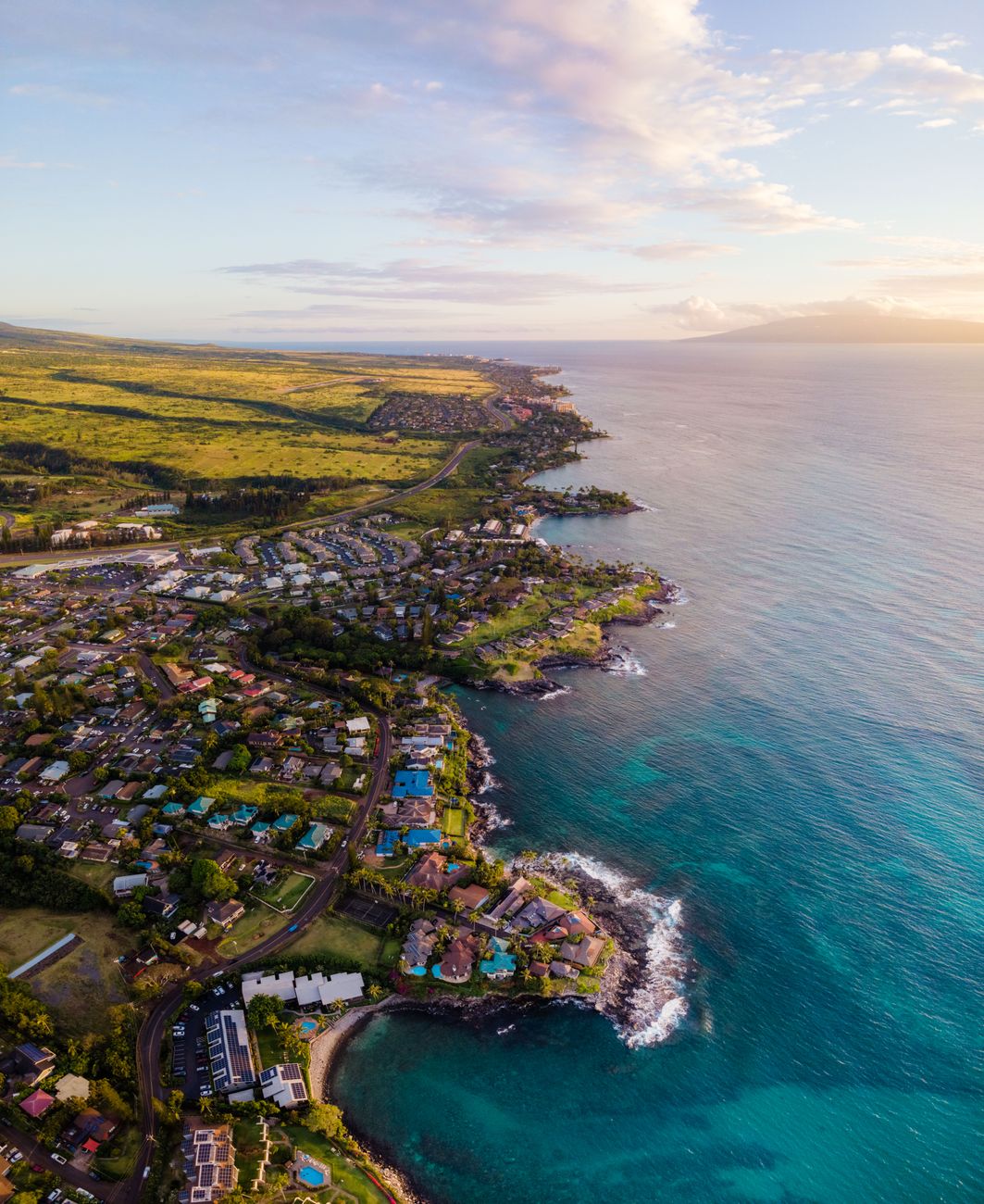 Photo by Griffin Wooldridge Stunning aerial shot of Lahaina, Hawaii coastline during sunset, showcasing vibrant townscape and ocean views.