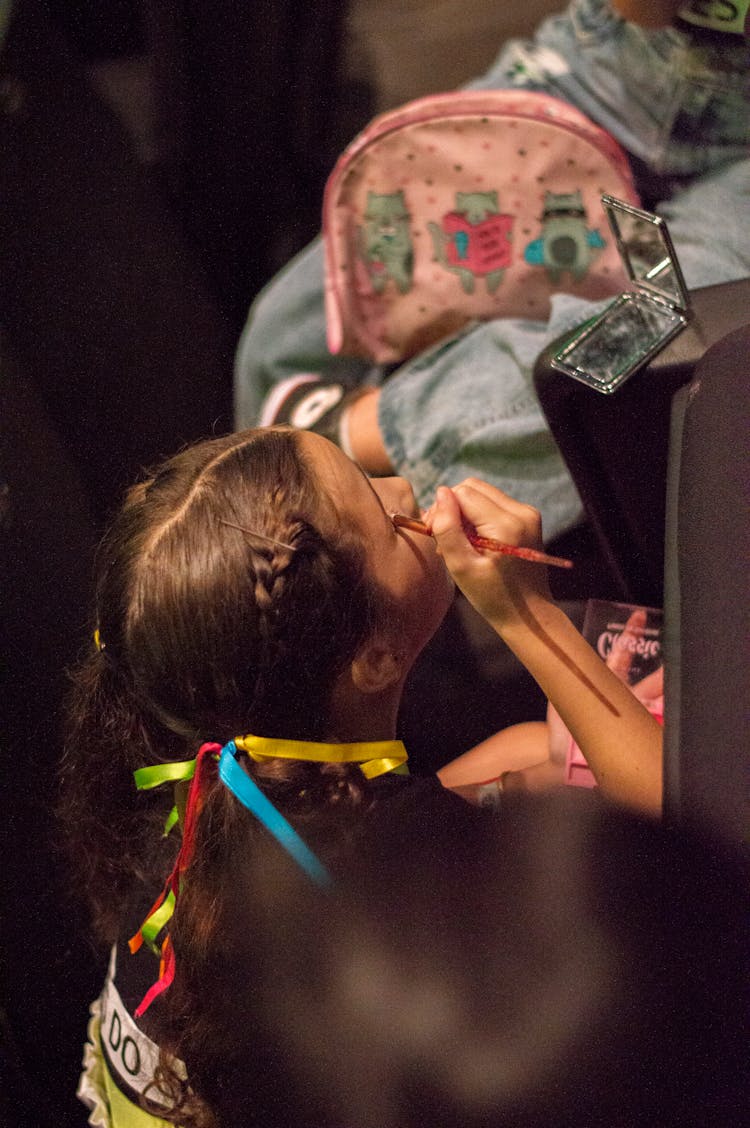 A Girl Doing Her Makeup In Preparation For A Performance 