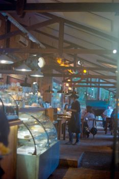 A warmly lit restaurant in Asunción, Paraguay, showcasing customers and ambient lighting.
