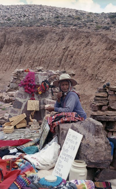 A senior woman happily selling her handmade crafts at an outdoor market