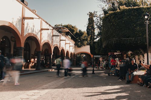 People Walking on Pavement on the Street