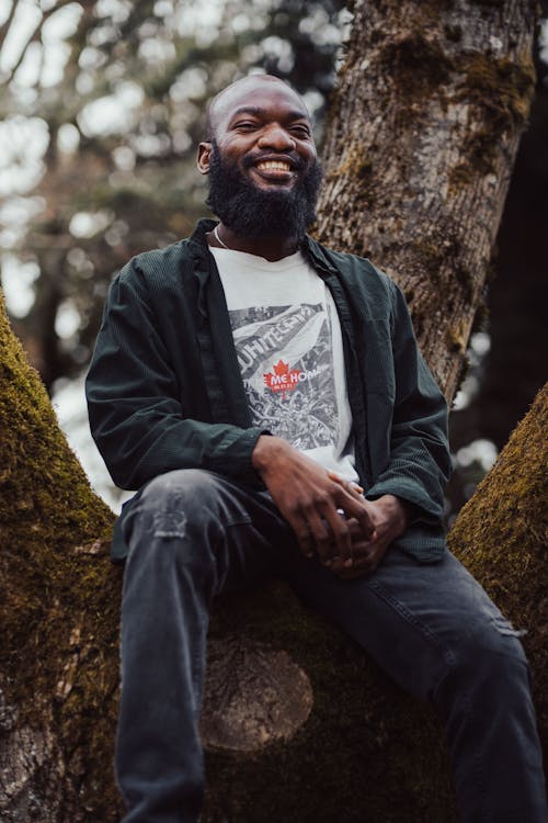 African Man Sitting on a Tree 