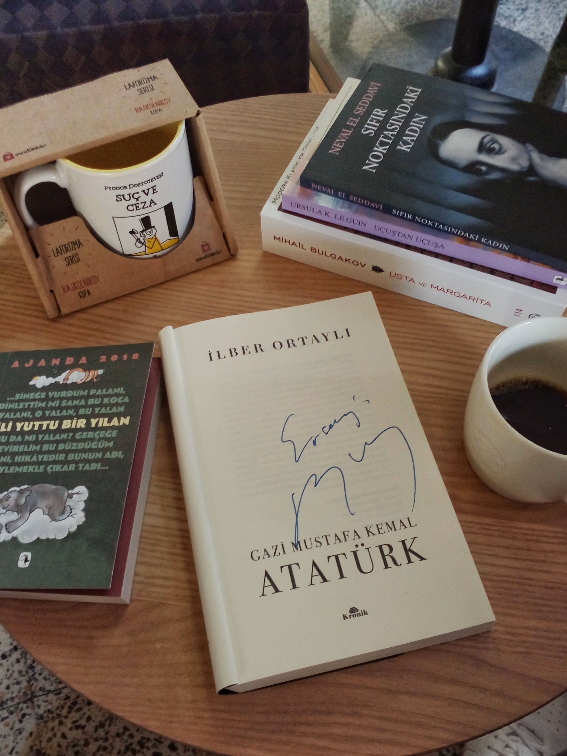 Cozy setup of books and coffee on a table in İzmir, Turkey.