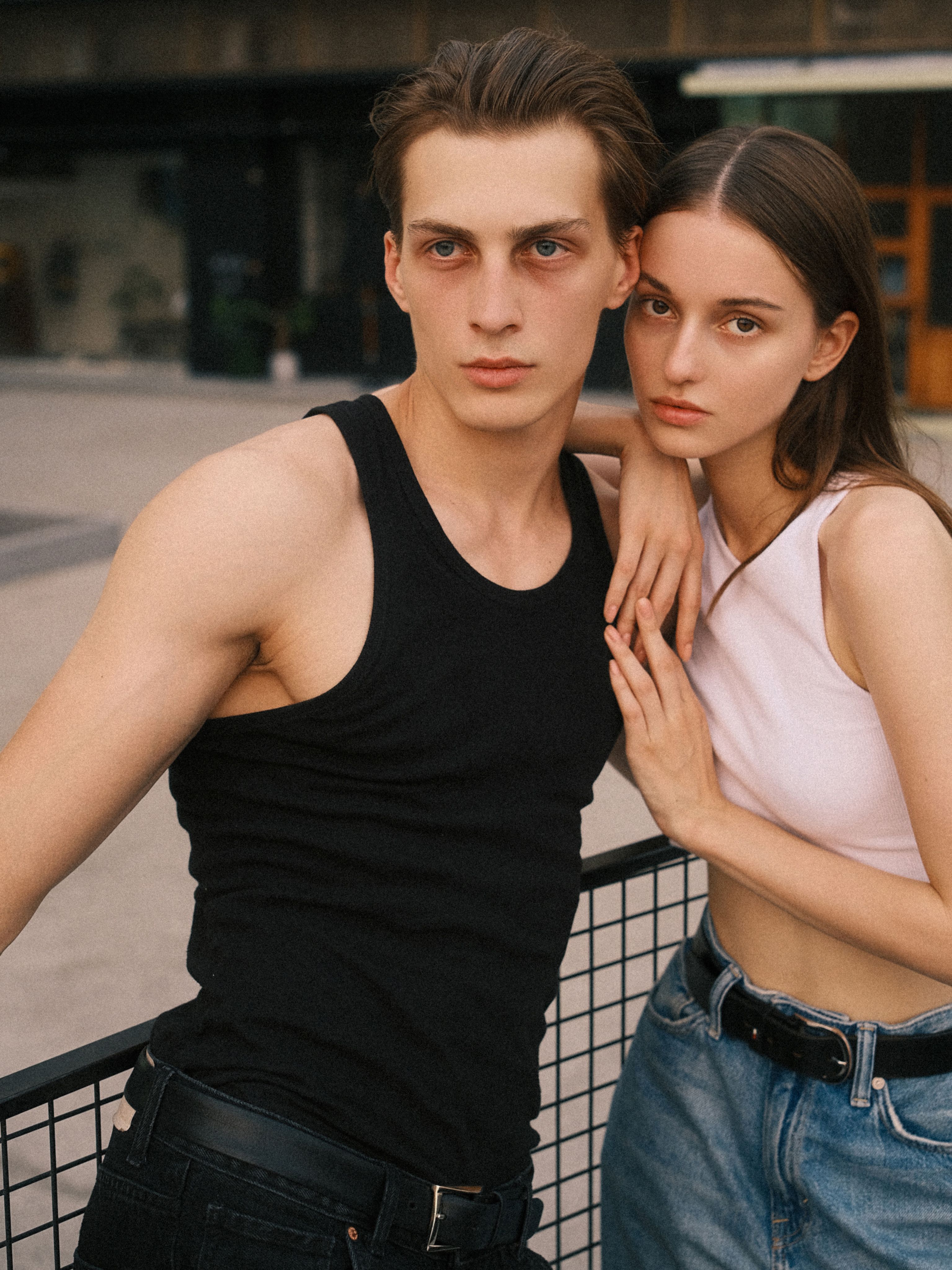 Young models in casual urban fashion posing outdoors, showcasing contemporary styles.