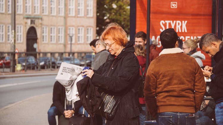 Photo Of A Group Of People Waiting In The Street