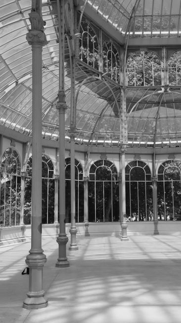 Elegant black and white interior shot of Palacio de Cristal in Madrid, Spain.