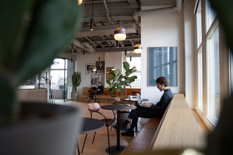 Man And Woman Working At Cafe