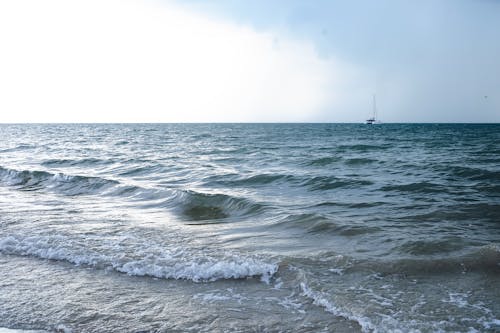 Scenic View of Sea and a Yacht in the Distance 