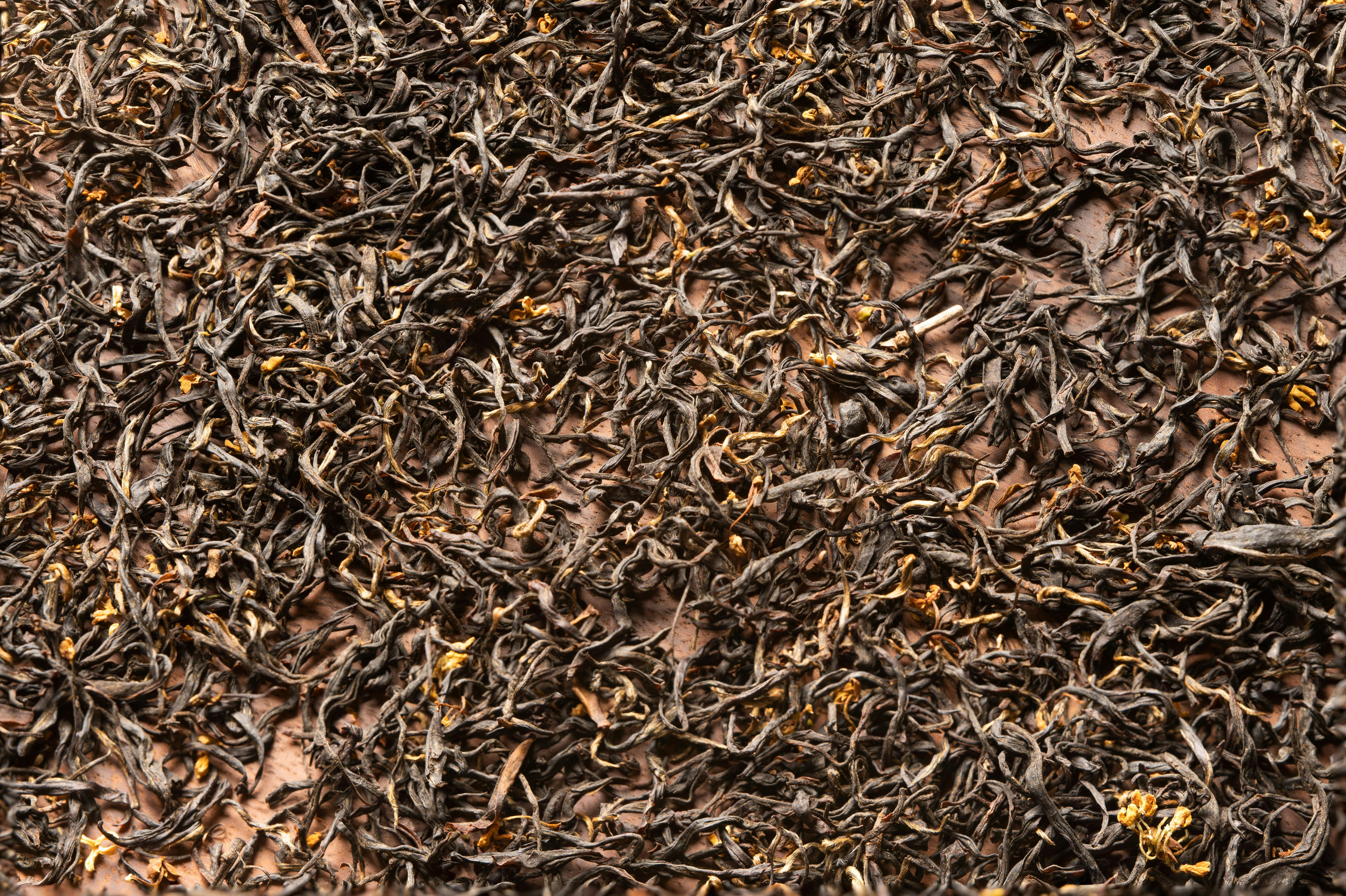 Detailed close-up of organic loose leaf black tea with rich texture.