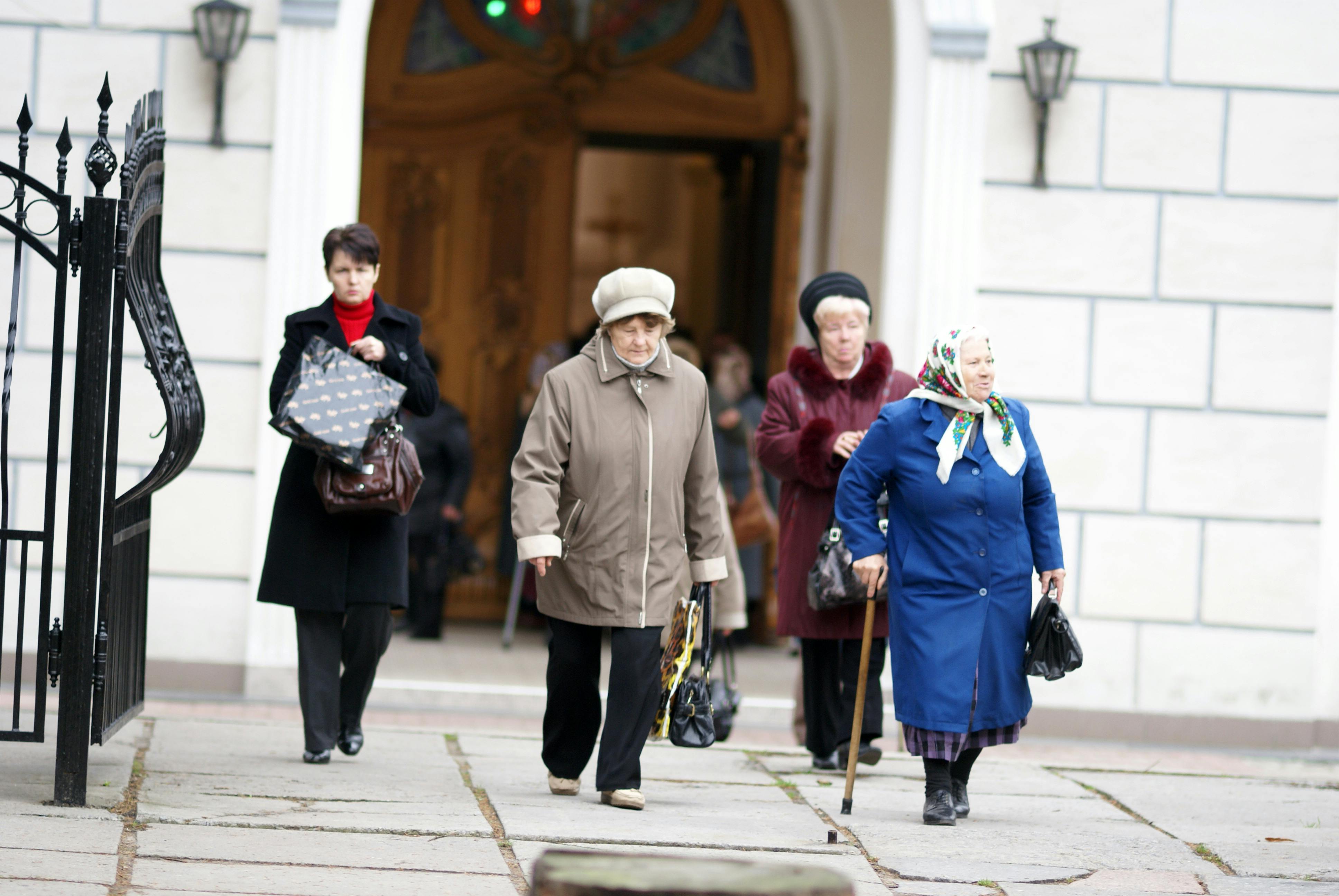 women walk past a church in the old town of moscow