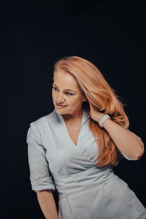 Young Redhead in a Dress Posing in Studio 