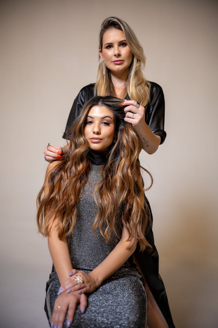 Stylist Working With Client Long Hair In Studio