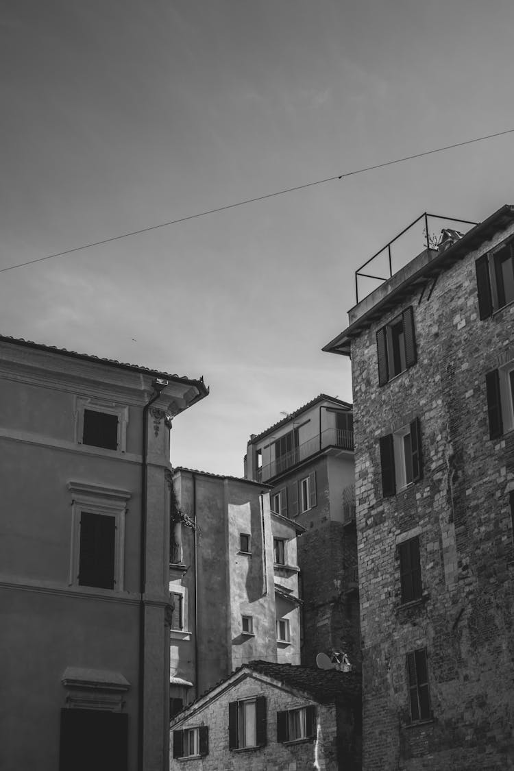 Stone And Brick Residential Buildings On Sky Background