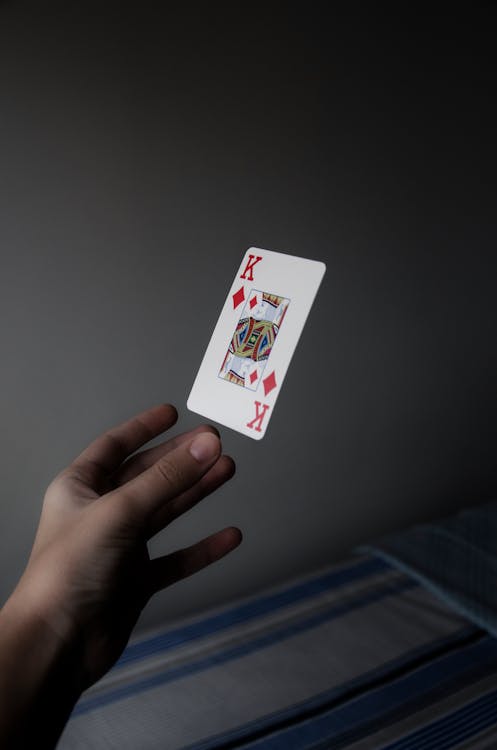 Free Person Holding King of Diamonds Playing Card Stock Photo