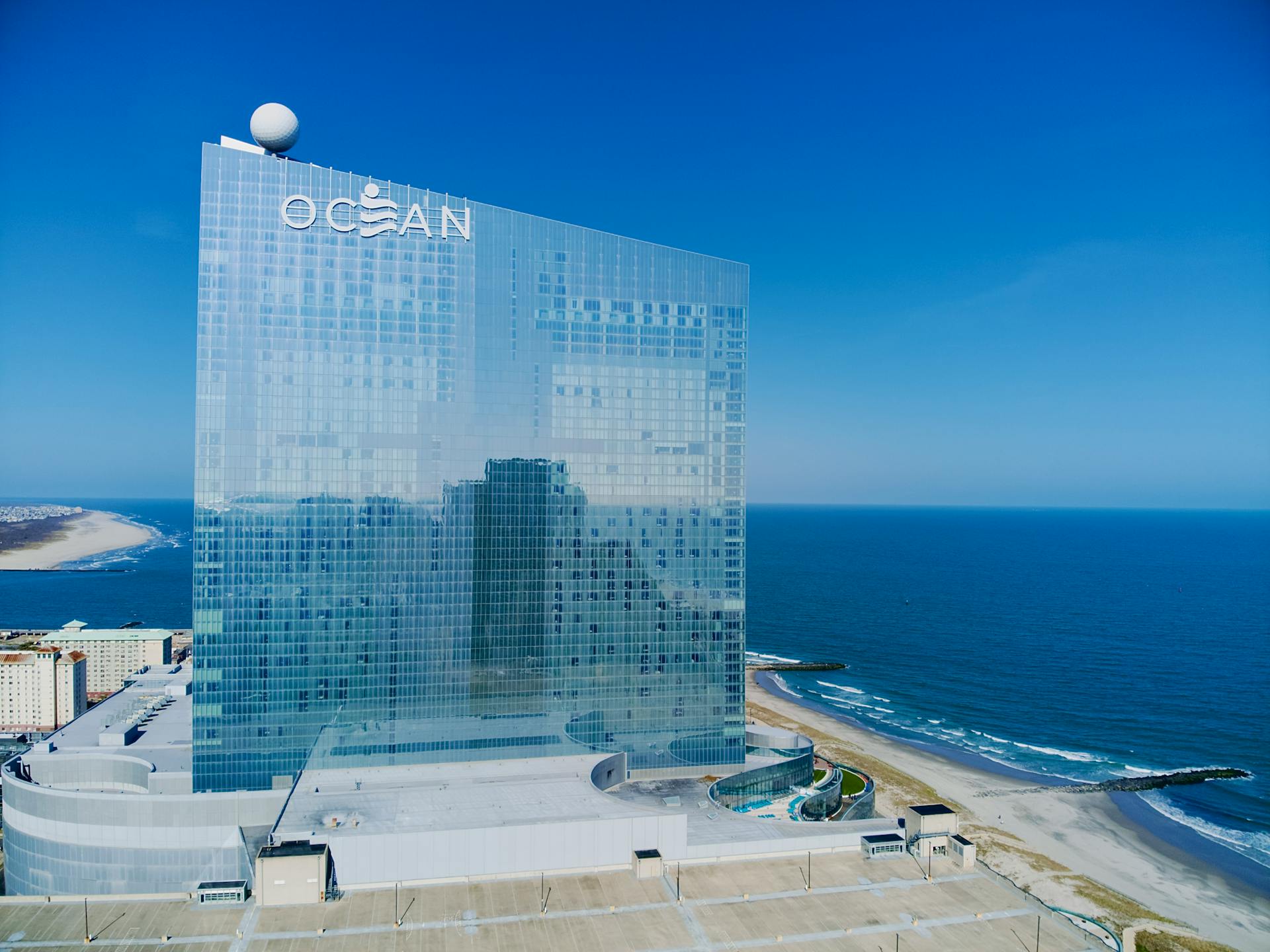 Aerial view of Ocean Casino Resort in Atlantic City with coastline and ocean reflections.