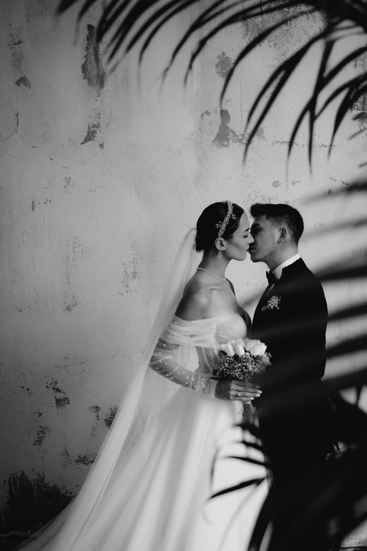 Newlyweds Kissing In Black And White