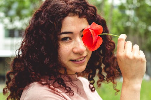 Free Woman Holding Red Flower Stock Photo