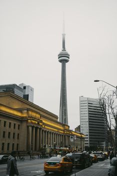 Capture of downtown Toronto with the CN Tower amidst urban hustle, showcasing city life.