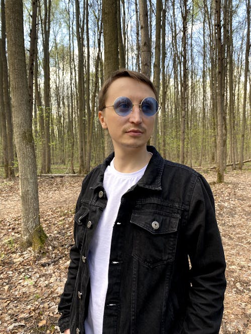 Man Wearing Blue Glasses in the Forest