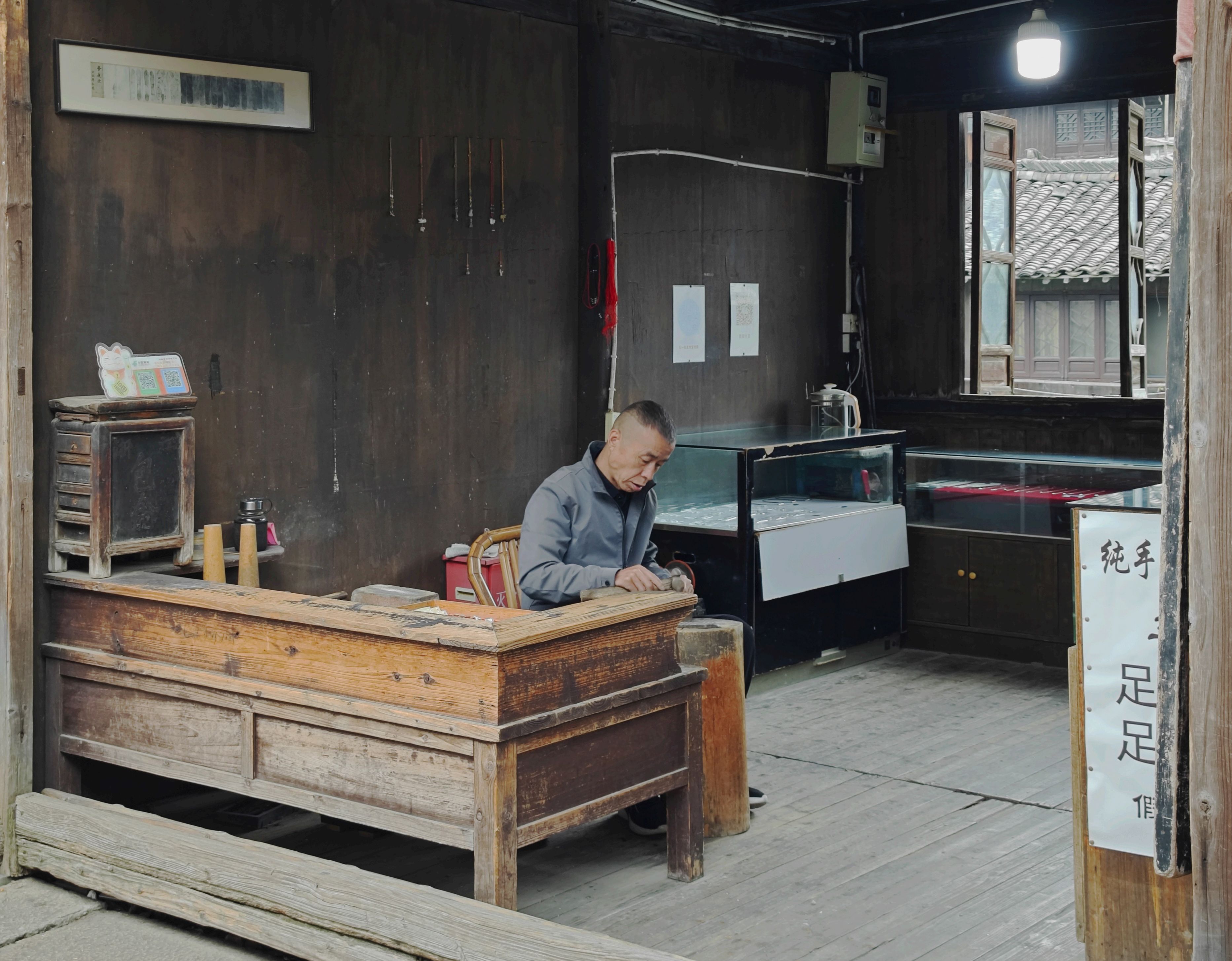 An artisan working in a rustic traditional workshop in Jia Xing Shi, capturing the essence of craftsmanship.