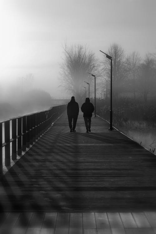 Couple Walking on Footbridge