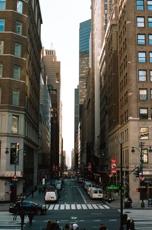 Free Iconic New York City street scene with tall skyscrapers and lively urban activity. Stock Photo