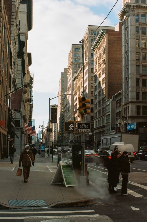 Free Street view of New York City with pedestrians and iconic architecture under winter sunlight. Stock Photo