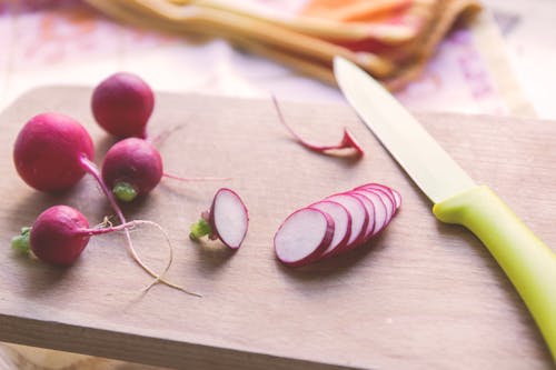 Green and Silver Kitchen Knife Beside Pink Onions