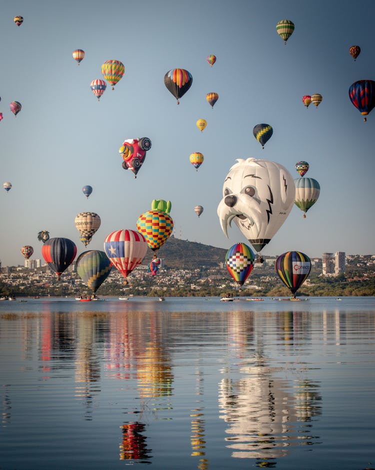 Colorful Balloons Flying Over Lake