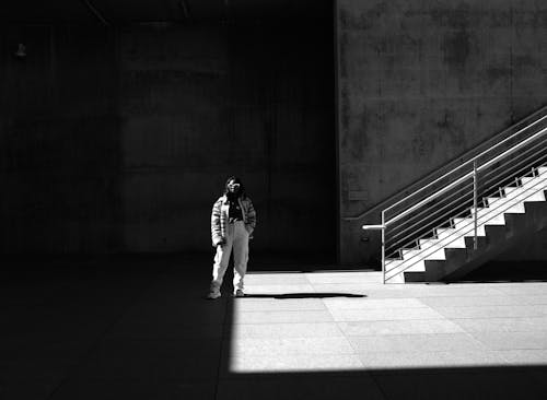 Woman Posing on Pavement near Stairs in Black and White