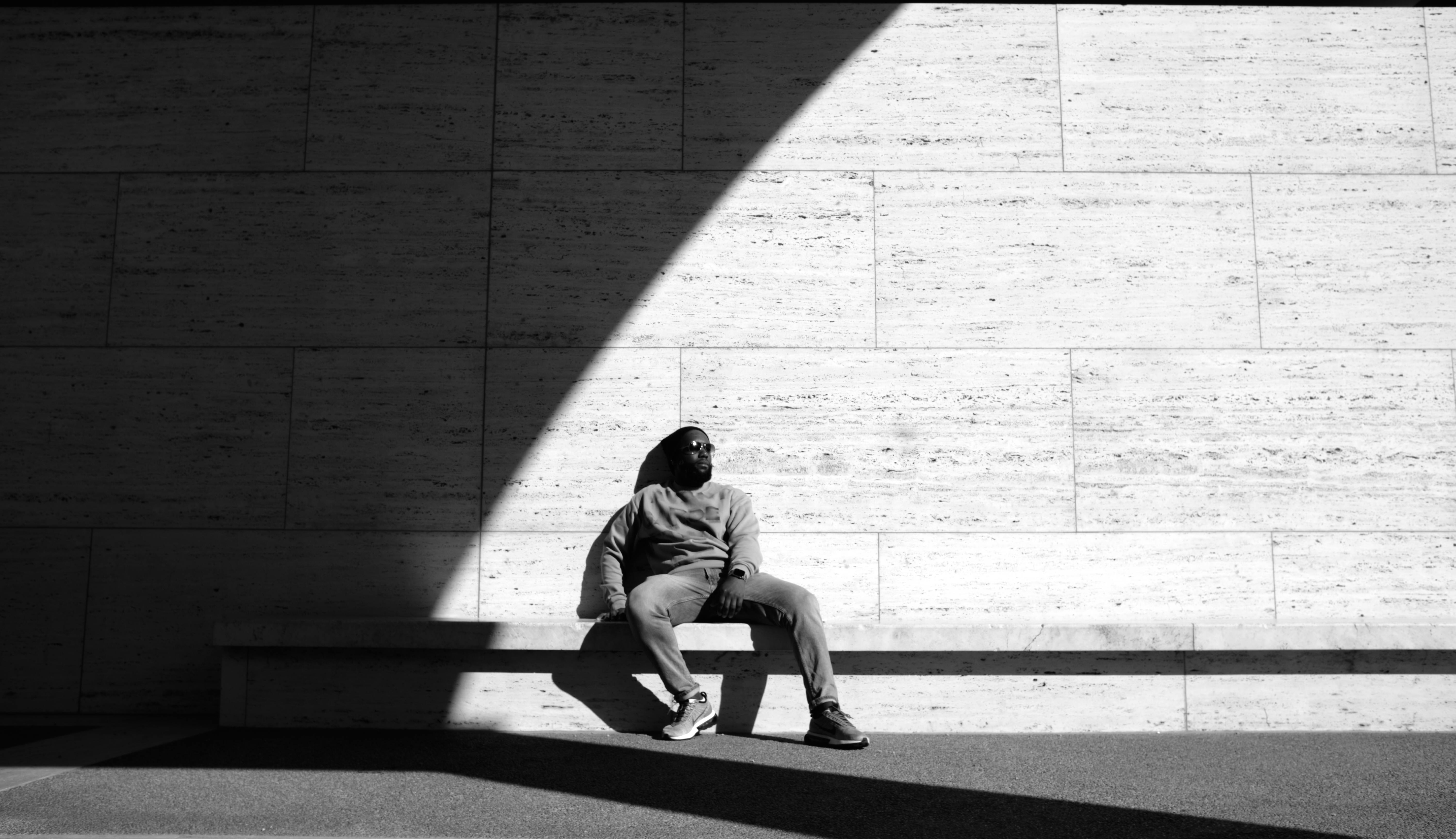 Man Walking in Front of Wall · Free Stock Photo