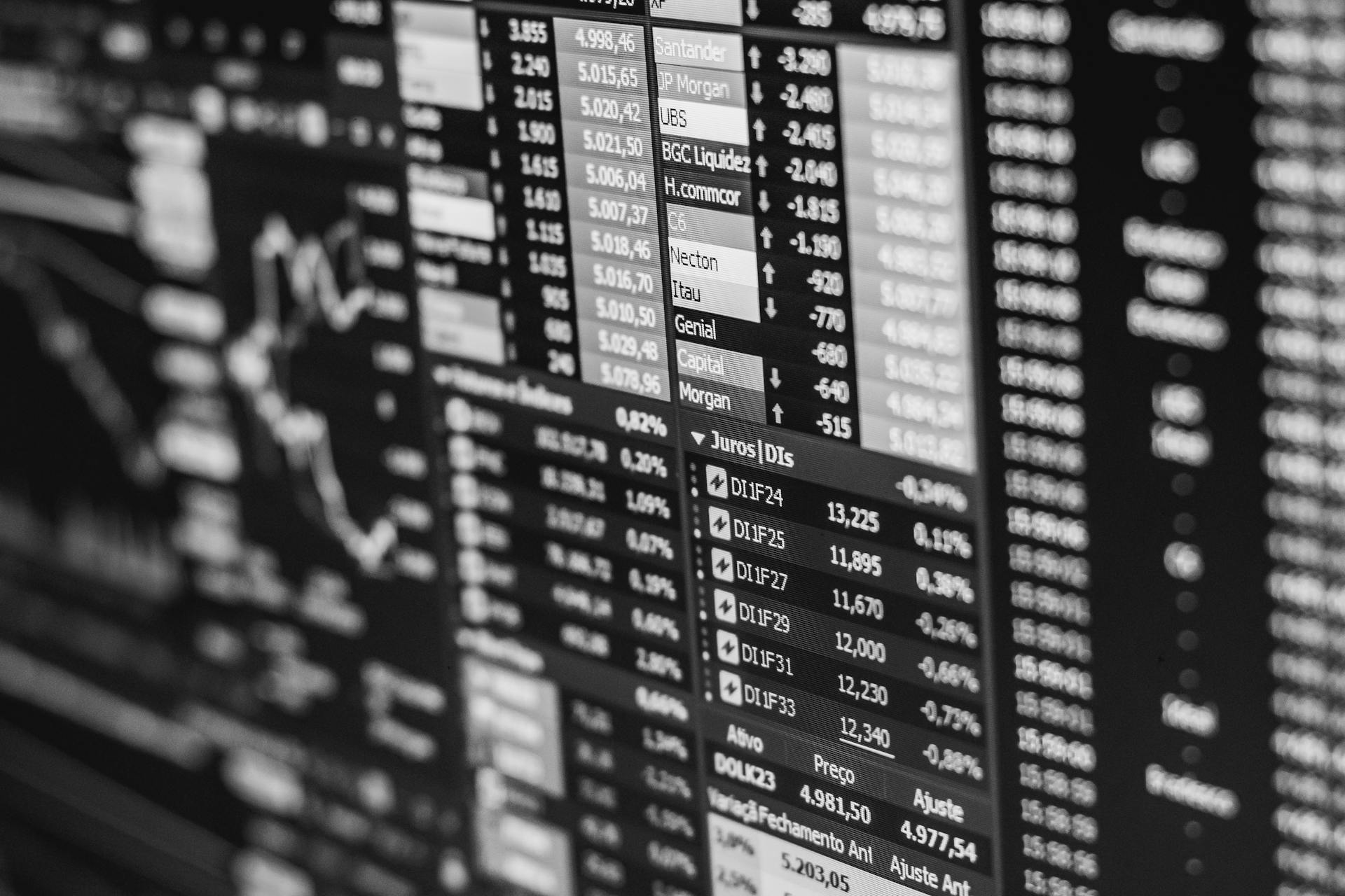 Monochrome image of stock market data on a screen, depicting financial information and trends.