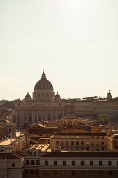 Aerial view of St. Peter's Basilica and Vatican City under a clear sky, highlighting its iconic architecture.